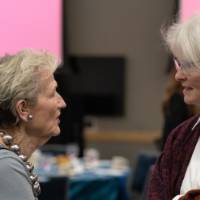 Two women chatting with each other at event